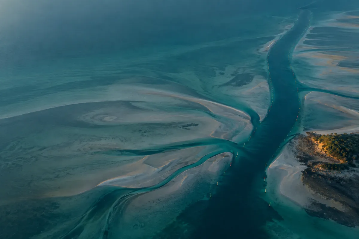 Three ochre islands of different sizes ringed by stepped teal depth bands, styled like a procedural bathymetric chart